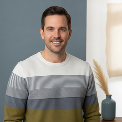 Portrait of Robert Hayes, a modern professional, smiling confidently and wearing the GRADON knit pullover against a clean bac